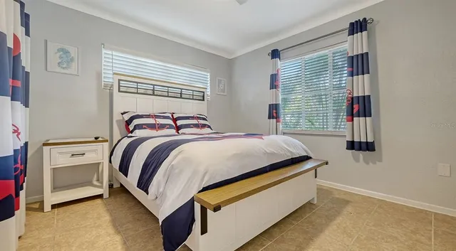 a bedroom with a bed and a window