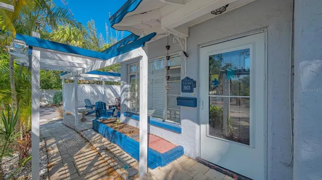 a view of a porch with chairs and floor to ceiling window