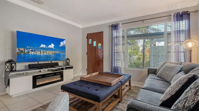 a living room with furniture and a floor to ceiling window