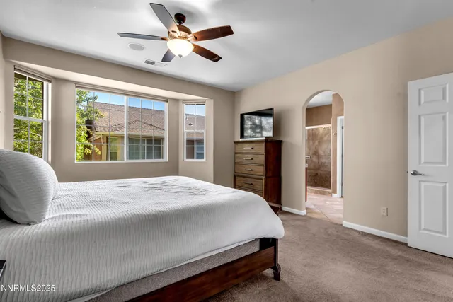a bedroom with a large bed and a large window