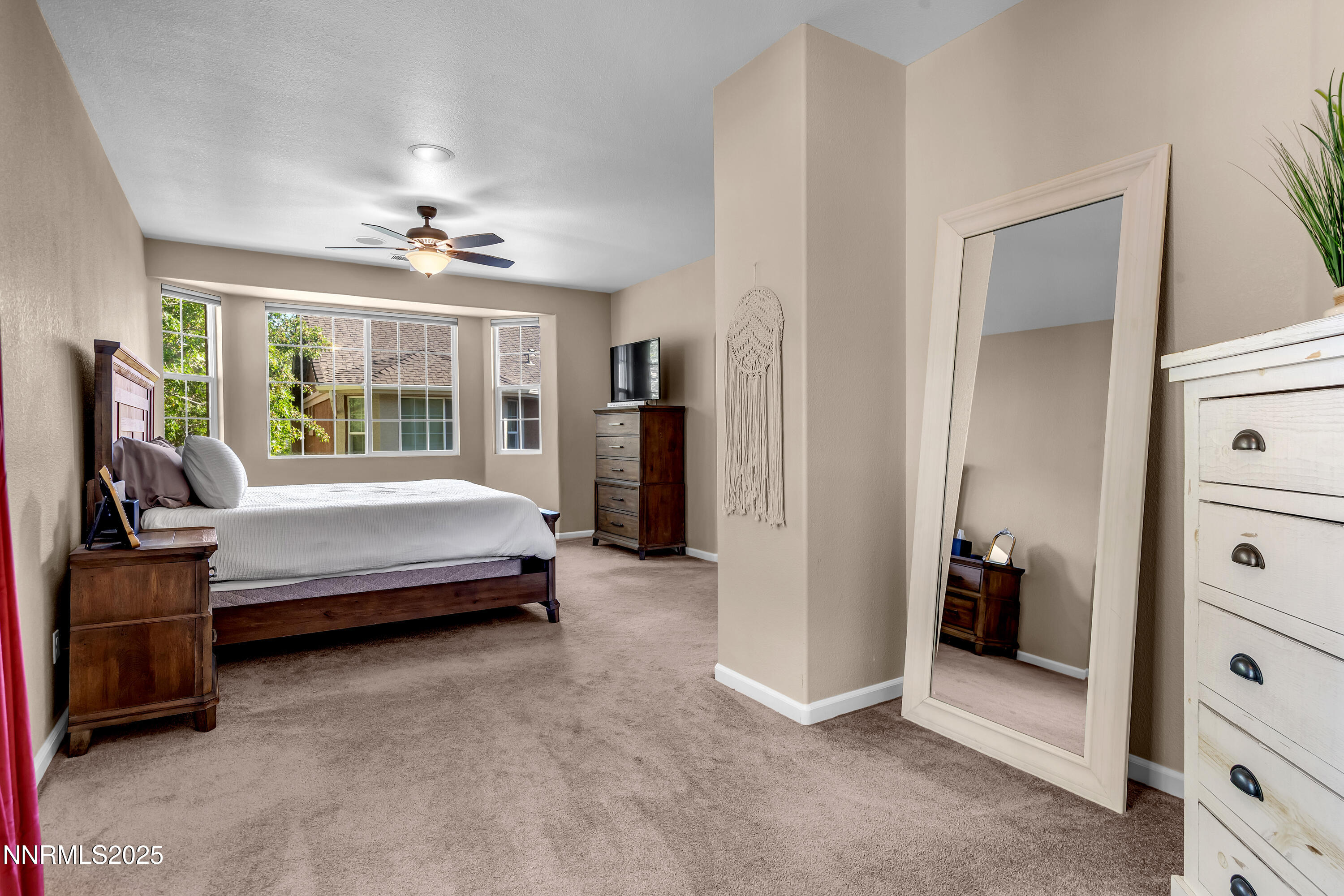 1811 Stetson Drive Reno, NV 89521 - Photo 12 of 34 a bedroom with a bed and a chandelier