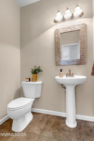 a bathroom with a sink toilet and mirror