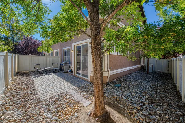 a view of a house with a yard and tree