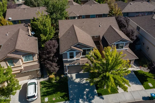 an aerial view of a house with a yard