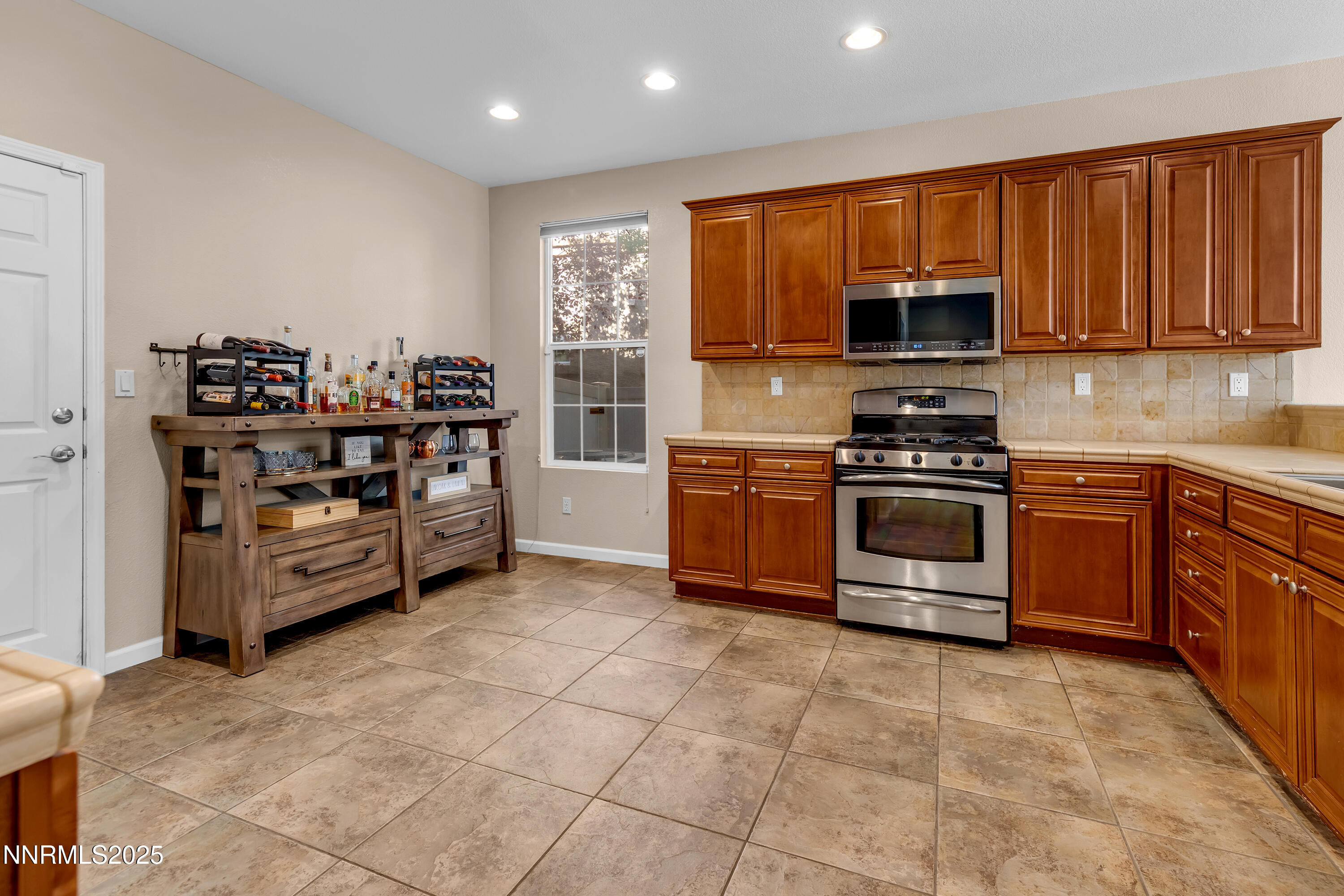 1811 Stetson Drive Reno, NV 89521 - Photo 7 of 34 a kitchen with stainless steel appliances a stove a sink a microwave and cabinets