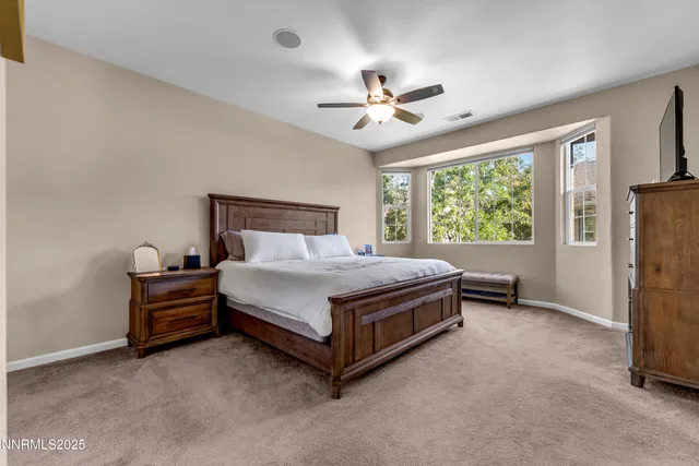 a bed sitting in a room next to a window