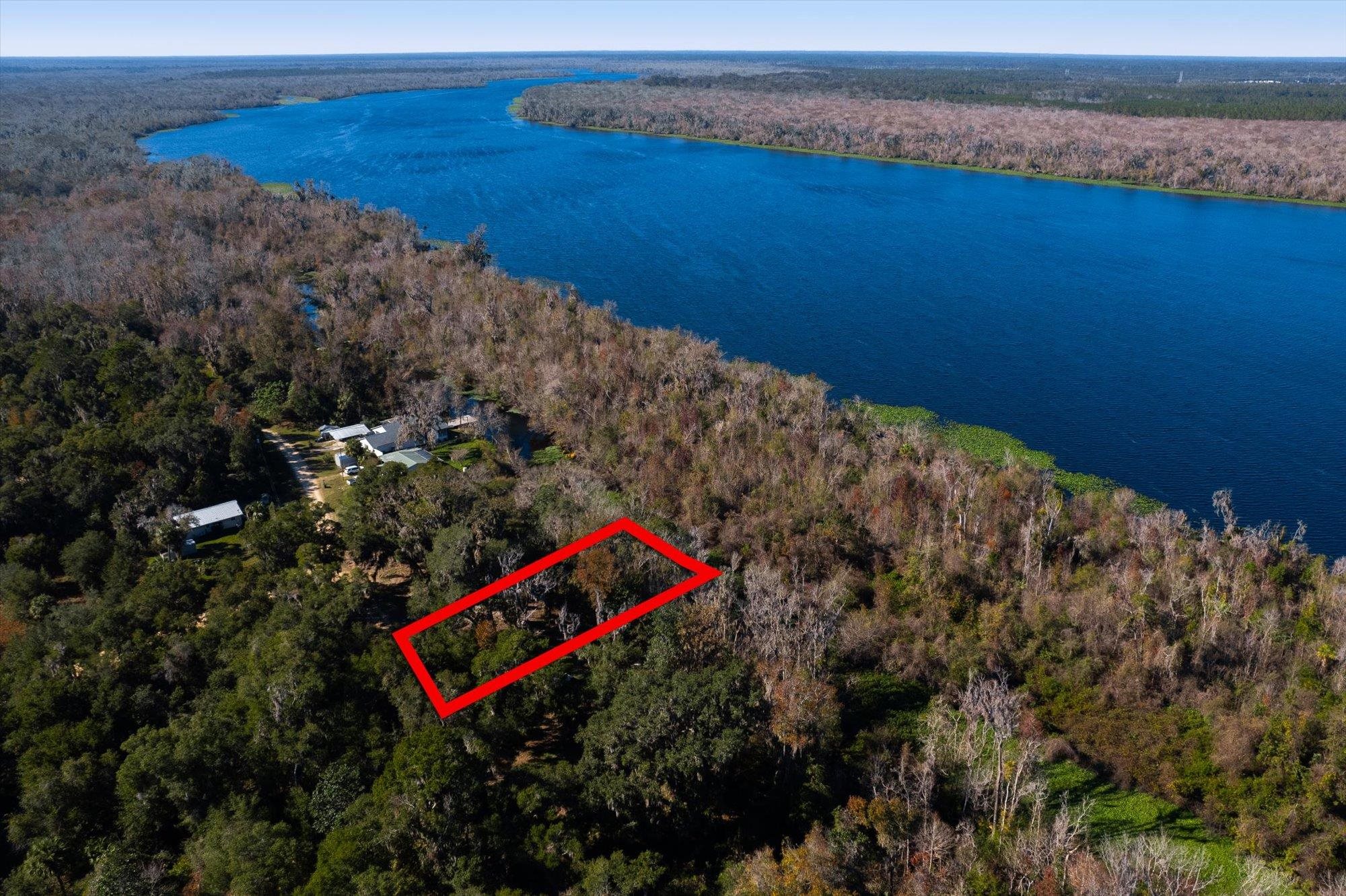 114 Ridgeline Avenue Satsuma, FL 32189 - Photo 5 of 14 a bench sitting in the middle of a lake
