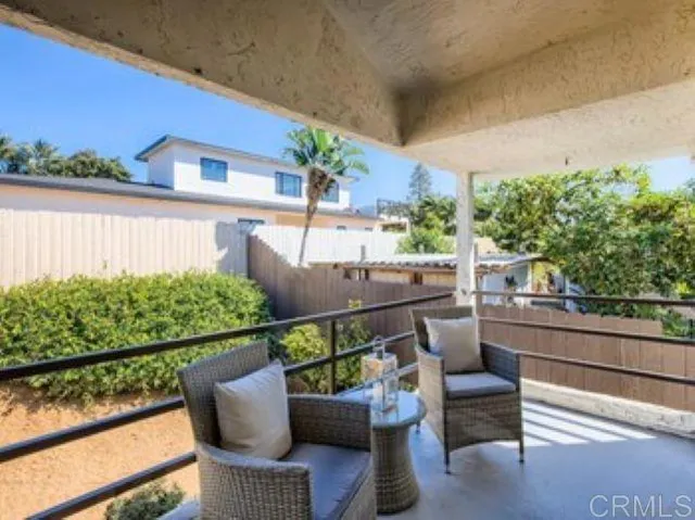 a view of a chair and tables in the balcony