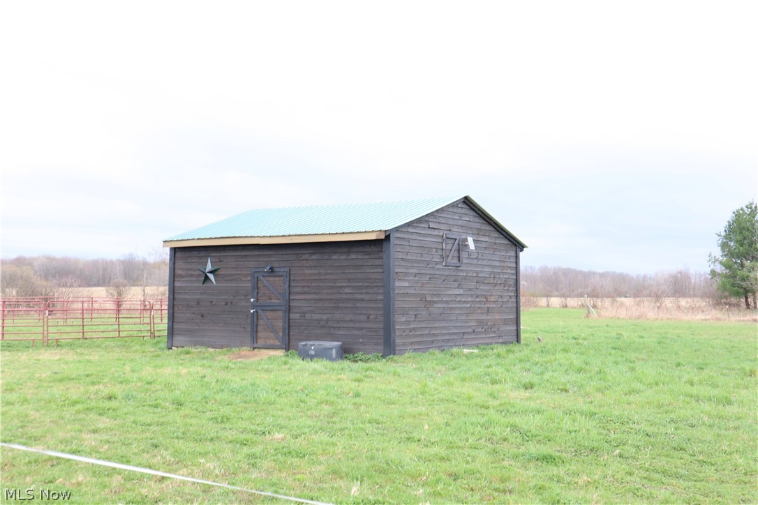 2212 Sentinel Road Dorset, OH 44032 - Photo 6 of 24 View of shed / structure with a rural view and a yard