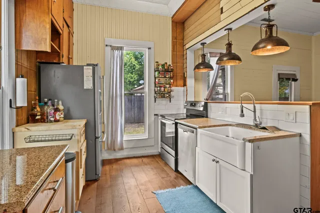a kitchen with a sink and a refrigerator