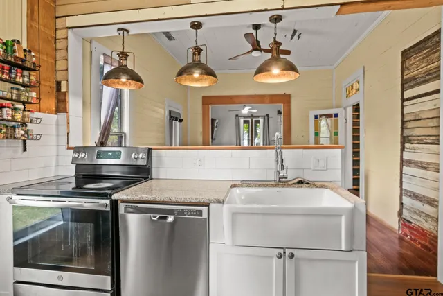 a kitchen with stainless steel appliances granite countertop a sink and cabinets