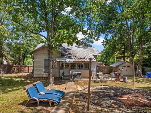 a view of a house with backyard porch and sitting area