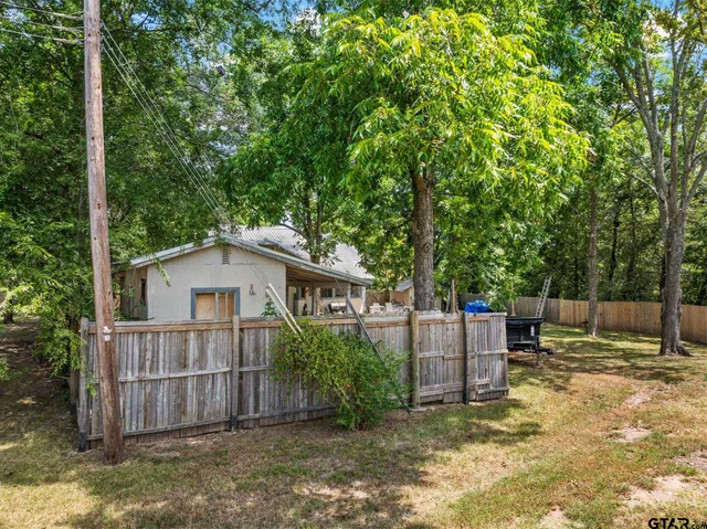 a white house that has tree in front of it