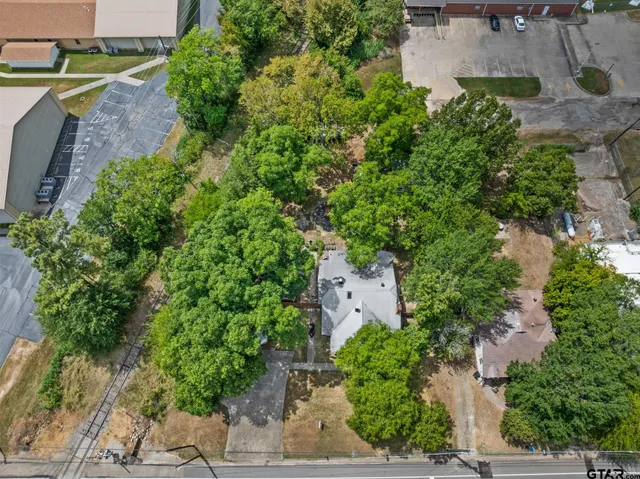 an aerial view of a house with garden space and street view