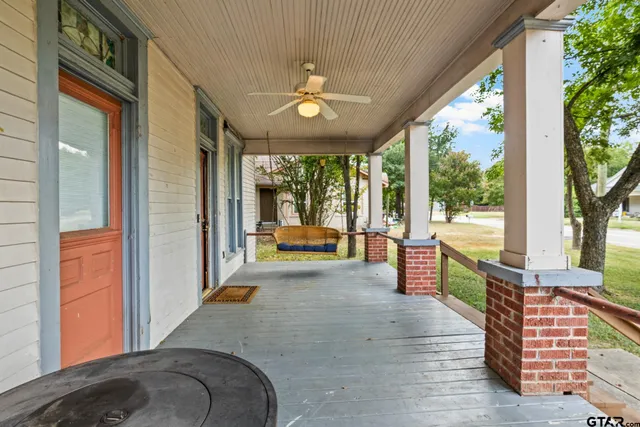 a view of a porch with wooden floor and outdoor space