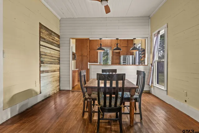 a view of a dining room with furniture and wooden floor