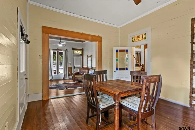 a view of a dining room with furniture and wooden floor
