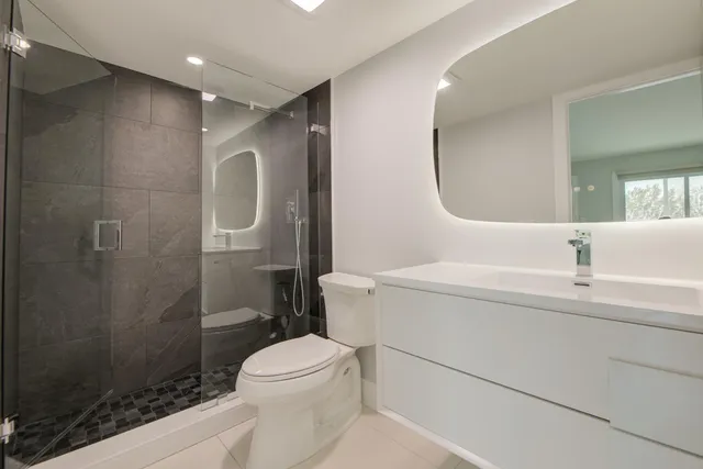 an aerial view of residential houses with outdoor space and river