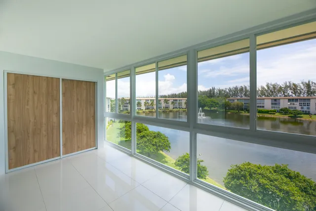a large kitchen with a large counter top stainless steel appliances and cabinets
