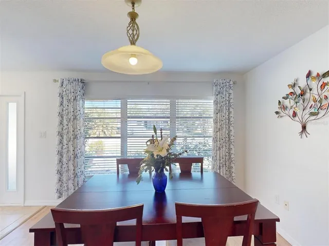 a kitchen with granite countertop a stove top oven a sink dishwasher and a refrigerator with wooden floor