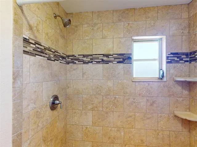 a bathroom with a granite countertop sink and mirror