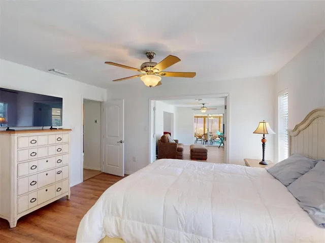 a bedroom with furniture window and wooden floor