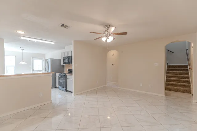 a view of an empty room with a kitchen
