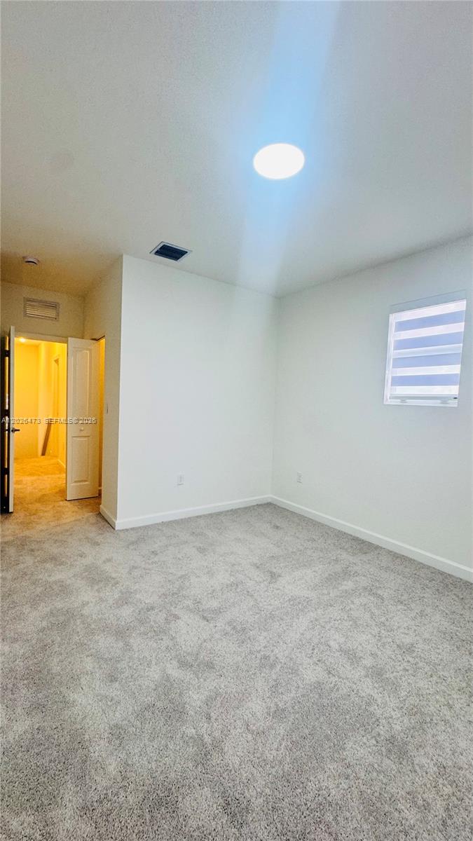 19479 Southwest 340th Street, Unit 1 Homestead, FL 33034 - Photo 14 of 58 an empty room with a window