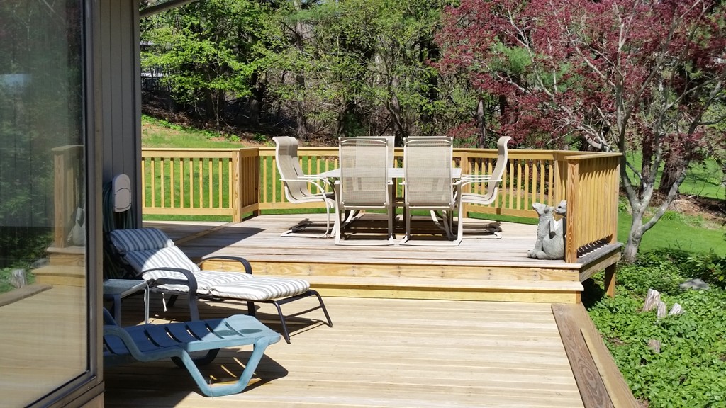 10 Ramshorn Road Sutton, MA 01590 - Photo 12 of 24 a view of a patio with table and chairs with wooden floor and fence