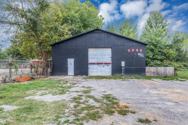 a backyard of a house with barbeque oven