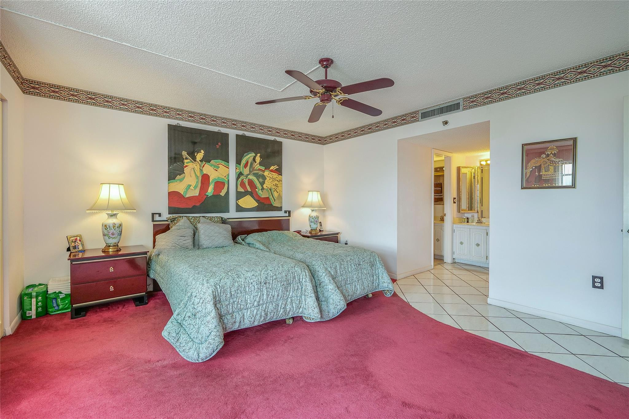 3910 Inverrary Boulevard, Unit 805B Lauderhill, FL 33319 - Photo 14 of 51 a bedroom with a bed and dresser with wooden floor