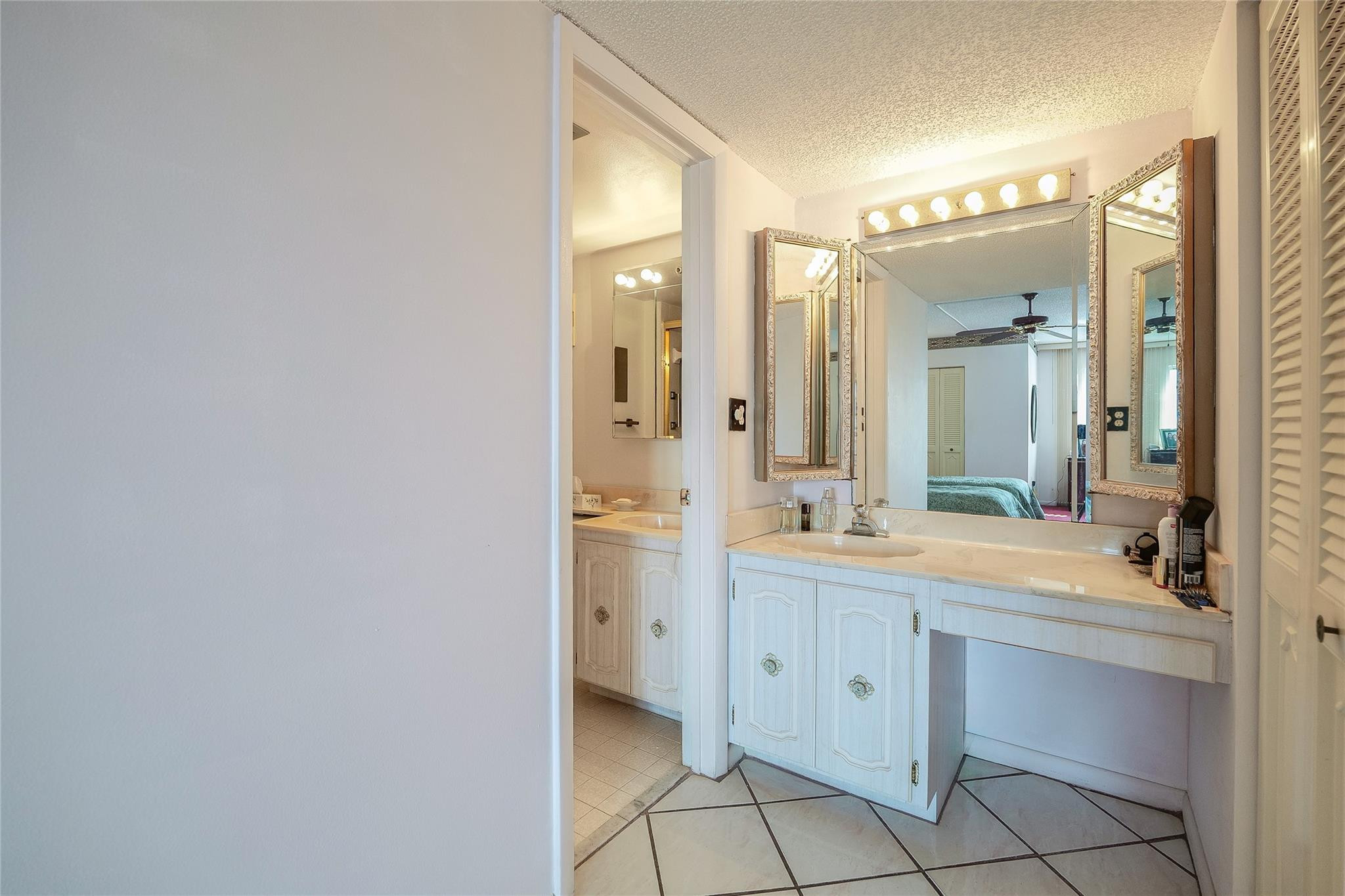 3910 Inverrary Boulevard, Unit 805B Lauderhill, FL 33319 - Photo 16 of 51 a spacious bathroom with a double vanity sink mirror and a