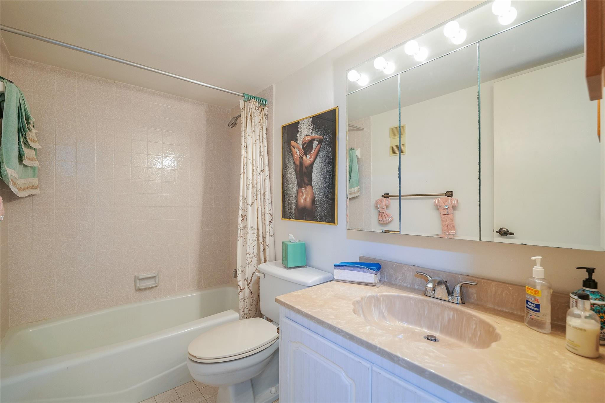 3910 Inverrary Boulevard, Unit 805B Lauderhill, FL 33319 - Photo 21 of 51 a bathroom with a sink a toilet and a large mirror