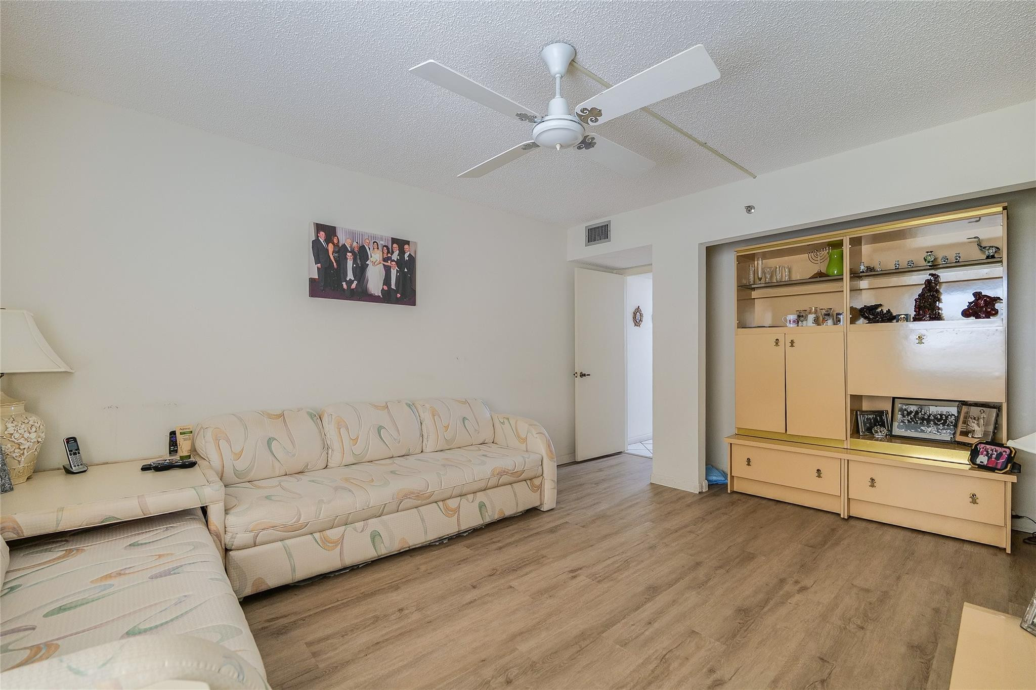 3910 Inverrary Boulevard, Unit 805B Lauderhill, FL 33319 - Photo 23 of 51 a living room with furniture and a flat screen tv