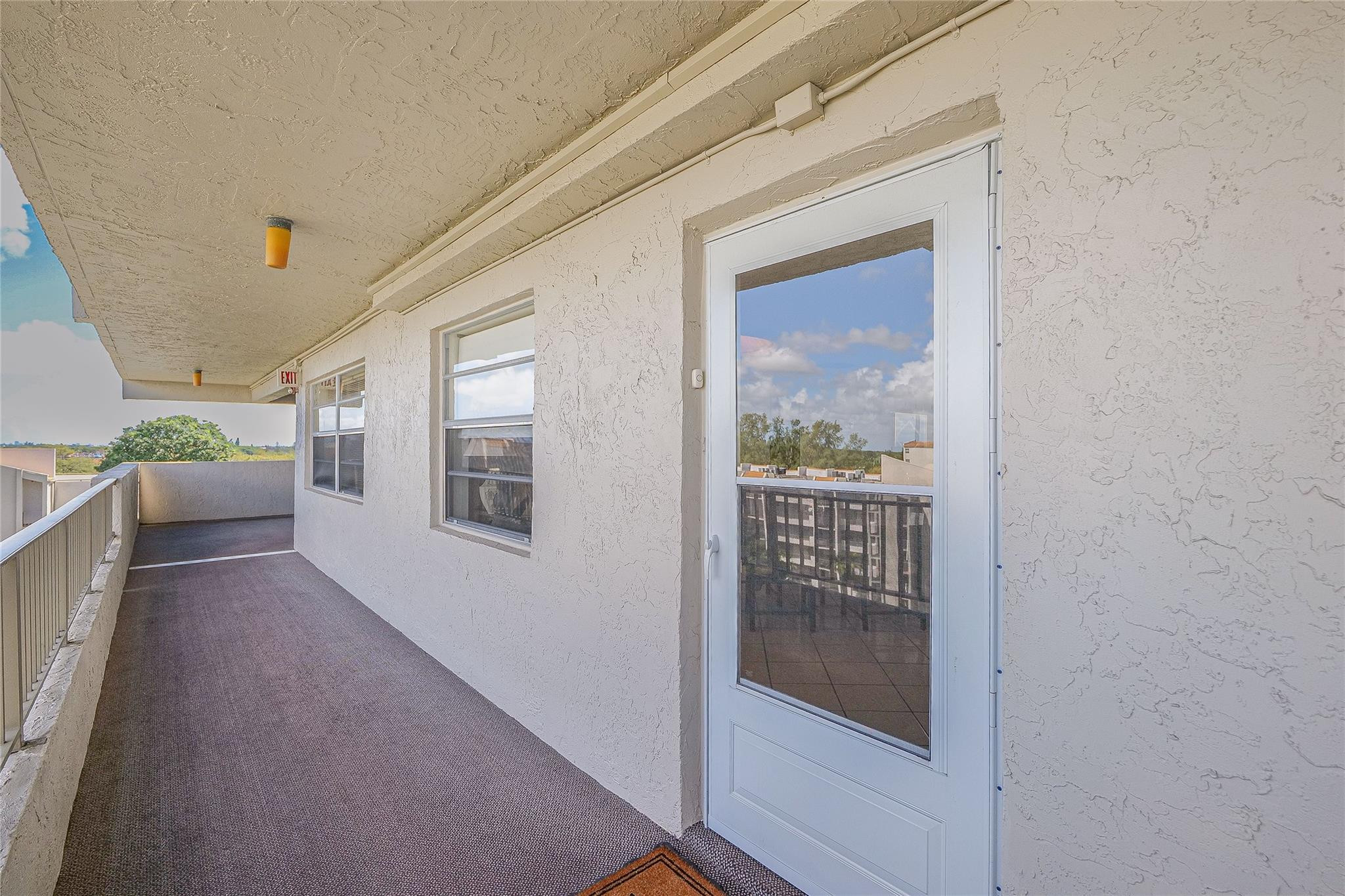 3910 Inverrary Boulevard, Unit 805B Lauderhill, FL 33319 - Photo 25 of 51 a view of a hallway with wooden floor and windows