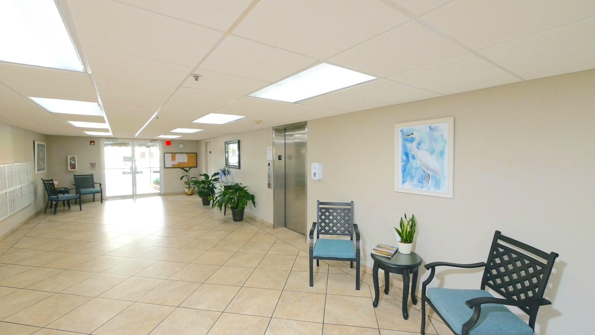 3910 Inverrary Boulevard, Unit 805B Lauderhill, FL 33319 - Photo 46 of 51 a lobby with furniture and a potted plant
