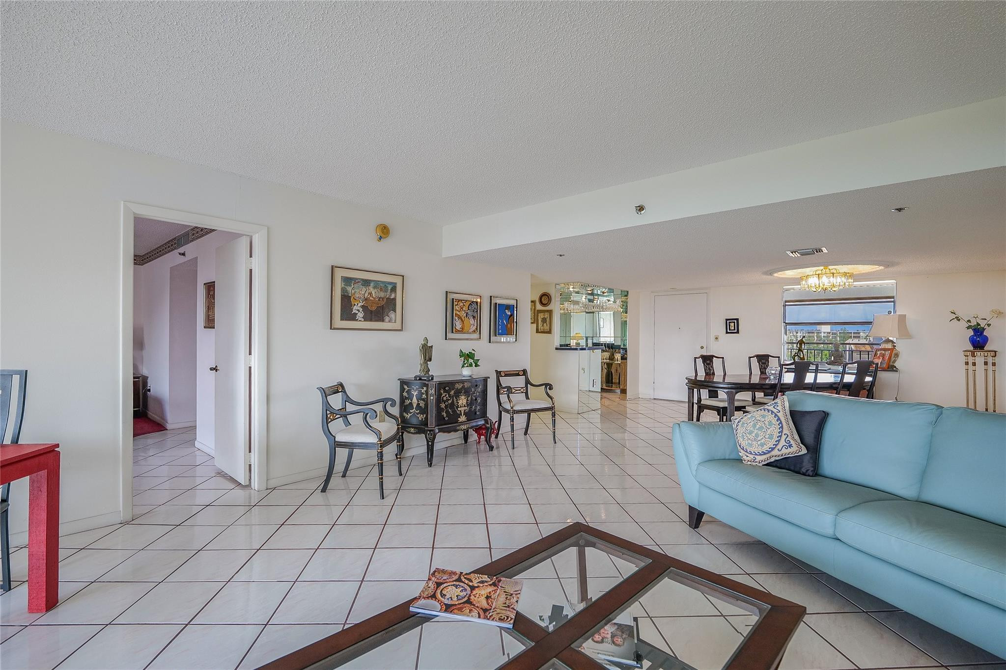 3910 Inverrary Boulevard, Unit 805B Lauderhill, FL 33319 - Photo 5 of 51 a living room with furniture a dining table and a potted plant