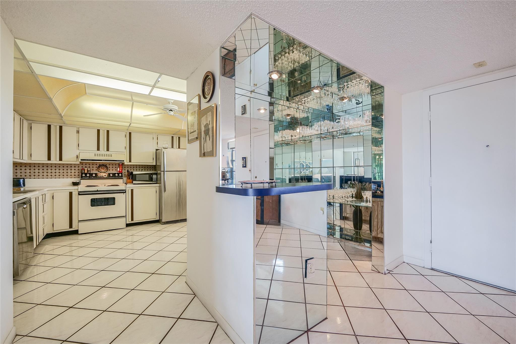 3910 Inverrary Boulevard, Unit 805B Lauderhill, FL 33319 - Photo 9 of 51 a kitchen with stainless steel appliances a stove top oven and a refrigerator