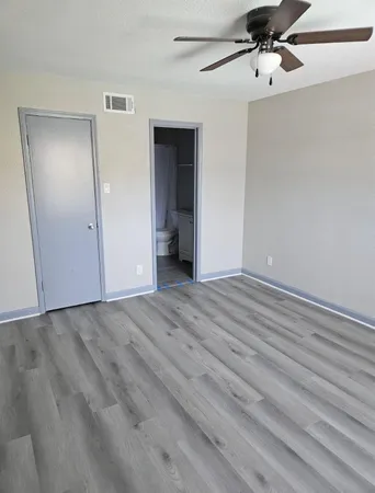 a view of an empty room with wooden floor