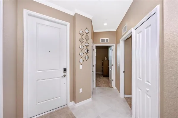 a dining room with furniture a chandelier and wooden floor
