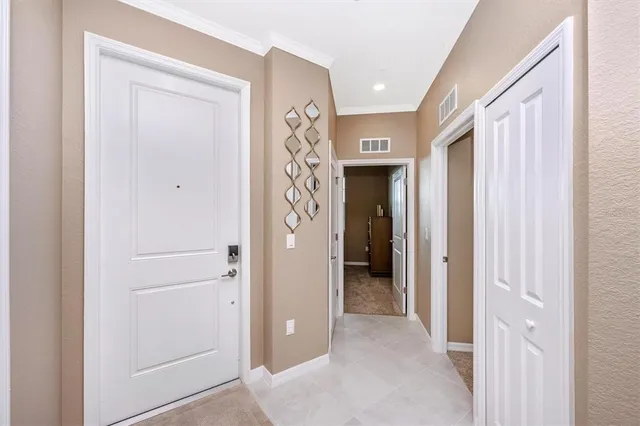 a dining room with furniture a chandelier and wooden floor