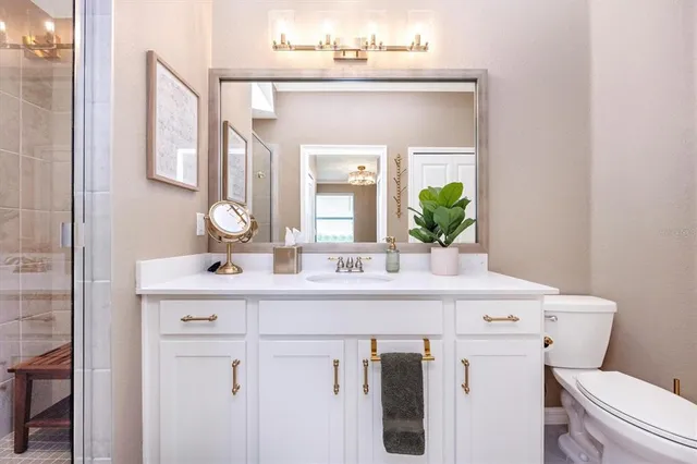 a front view of a house with glass windows and furniture