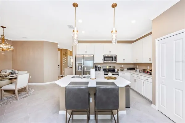 a living room with furniture kitchen view and a flat screen tv