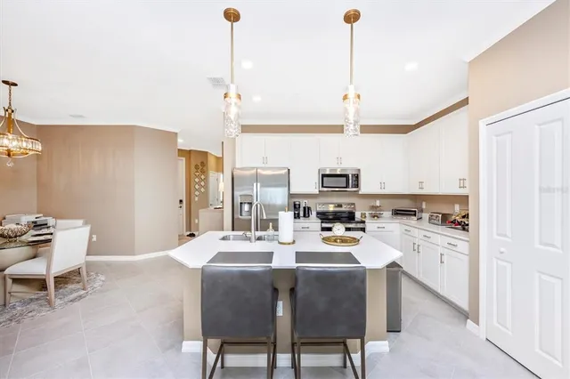 a living room with furniture kitchen view and a flat screen tv