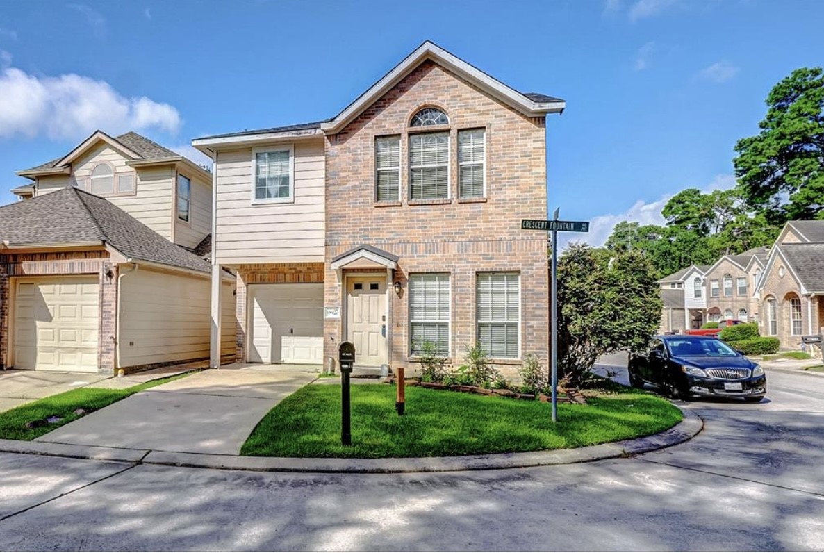 18927 Crescent Fountain Road Spring, TX 77388 - Photo 1 of 13 a front view of a house with a yard and garage