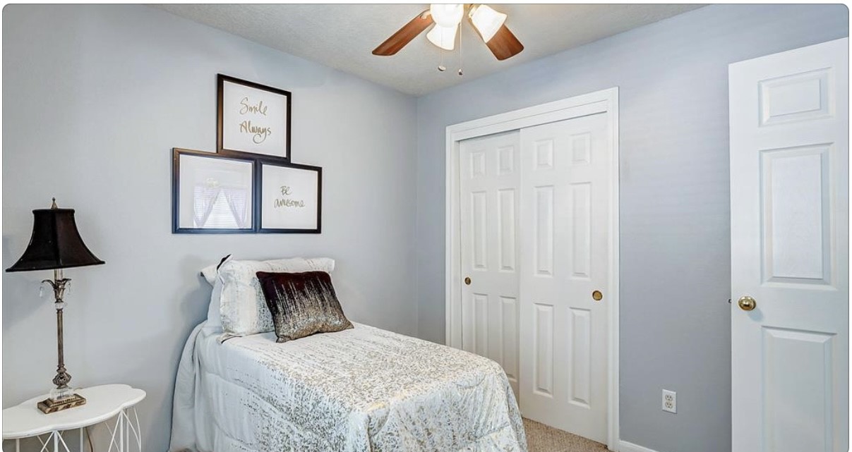 18927 Crescent Fountain Road Spring, TX 77388 - Photo 12 of 13 a bedroom with a bed and a chandelier