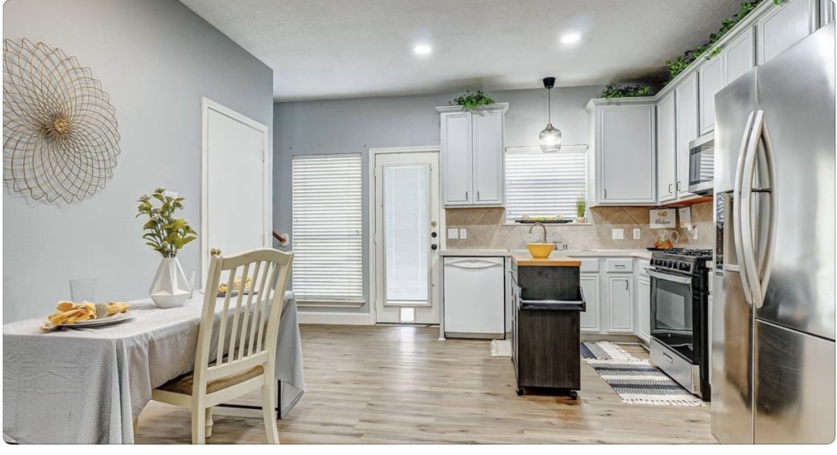 18927 Crescent Fountain Road Spring, TX 77388 - Photo 4 of 13 a kitchen with granite countertop a refrigerator a stove a sink a dining table and chairs