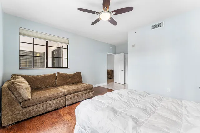 a bedroom with furniture and a large window