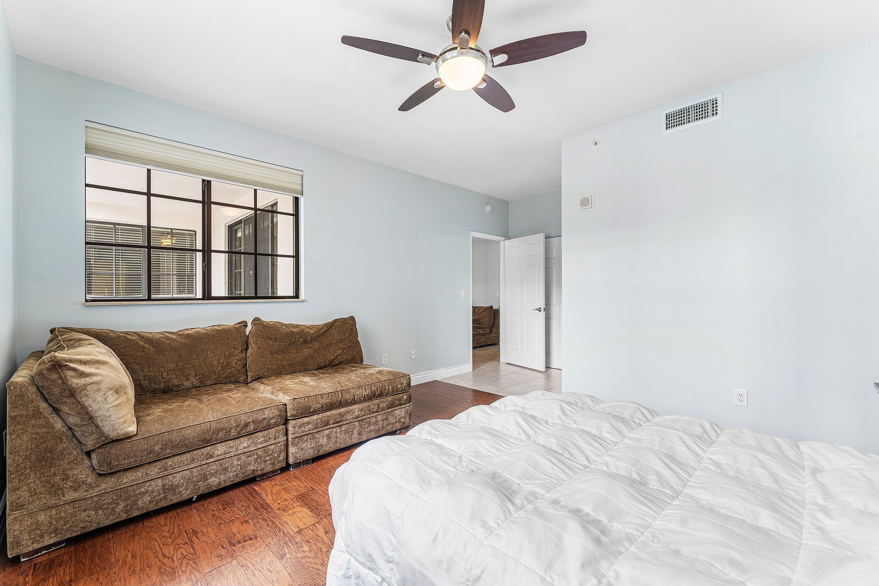 233 South Federal Highway, Unit 308 Boca Raton, FL 33432 - Photo 12 of 44 a bedroom with furniture and a large window