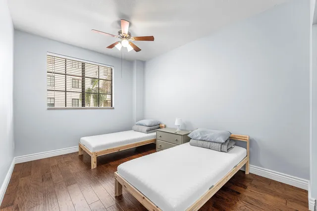 a bedroom with two beds and a window